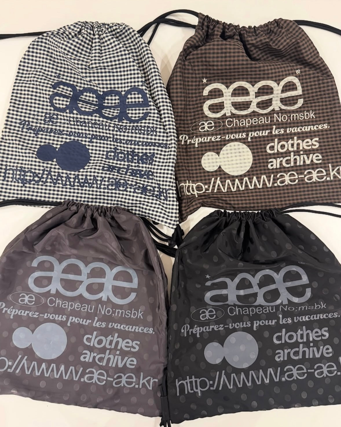 AEAE WEB LOGO CHECK GYM SACK (BROWN)